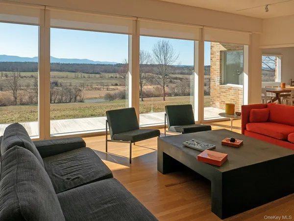 a living room with furniture a table and a large window