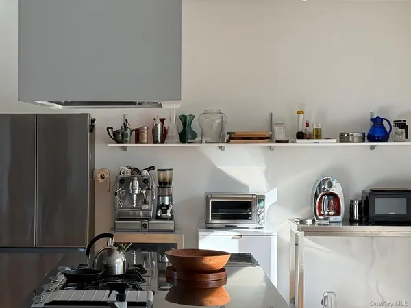 a kitchen with a refrigerator and a stove