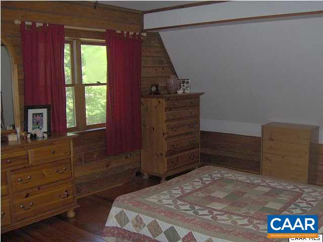 6037 Bell Road Dillwyn, VA 23936 - Photo 7 of 8 a bedroom with a bed and a dresser