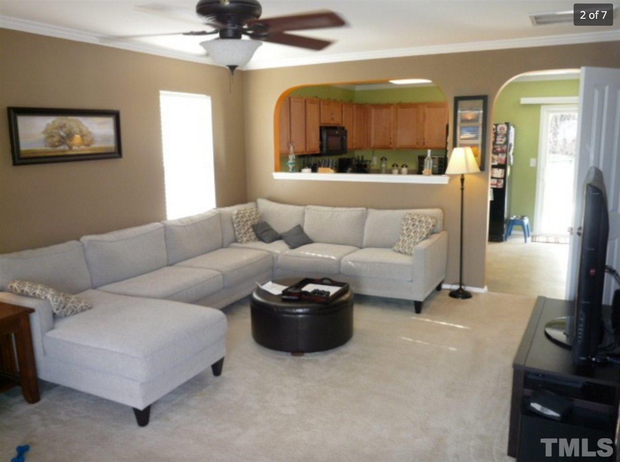 3025 Varcroft Road Knightdale, NC 27545 - Photo 2 of 7 a living room with furniture and a flat screen tv