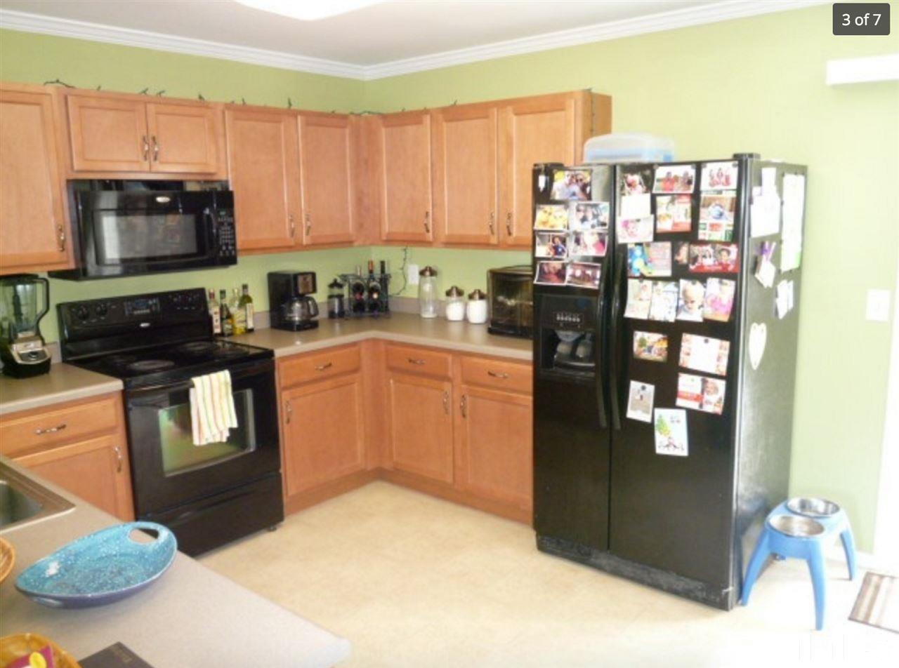 3025 Varcroft Road Knightdale, NC 27545 - Photo 3 of 7 a kitchen with stainless steel appliances granite countertop a refrigerator a stove top oven a sink and dishwasher