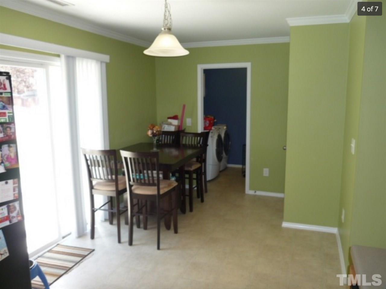 3025 Varcroft Road Knightdale, NC 27545 - Photo 4 of 7 a view of a dining room with furniture and a chandelier
