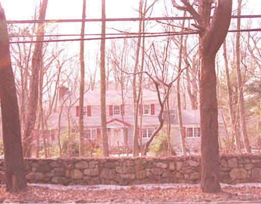 a backyard of a house with large trees