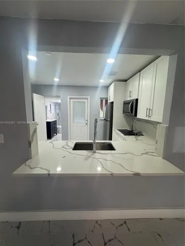 a view of a kitchen with a sink