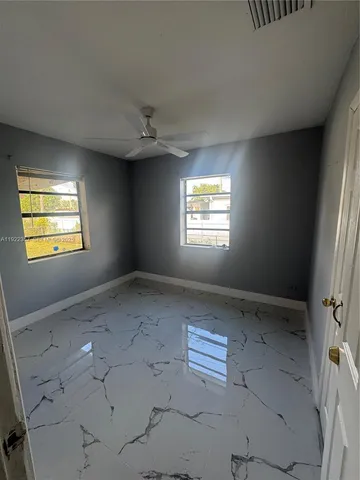 a view of an empty room with a window