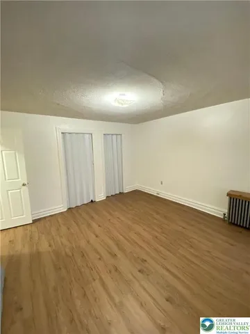 an empty room with wooden floor