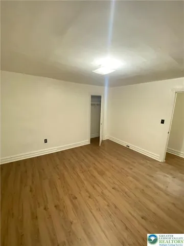 an empty room with wooden floor