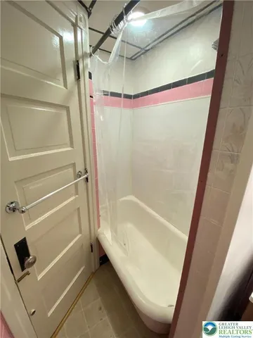 a bathroom with a tub and shower