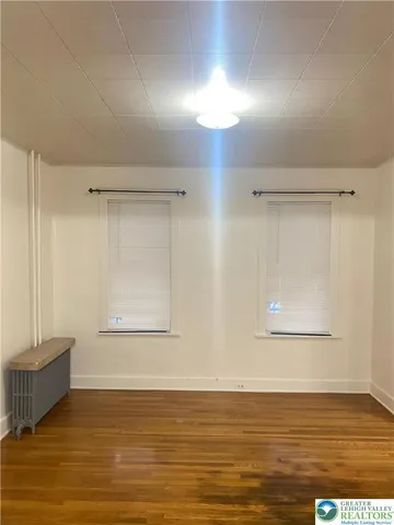 a view of a room with wooden floor and cabinet