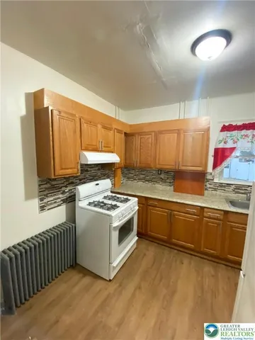 a kitchen with stainless steel appliances granite countertop a stove and a sink