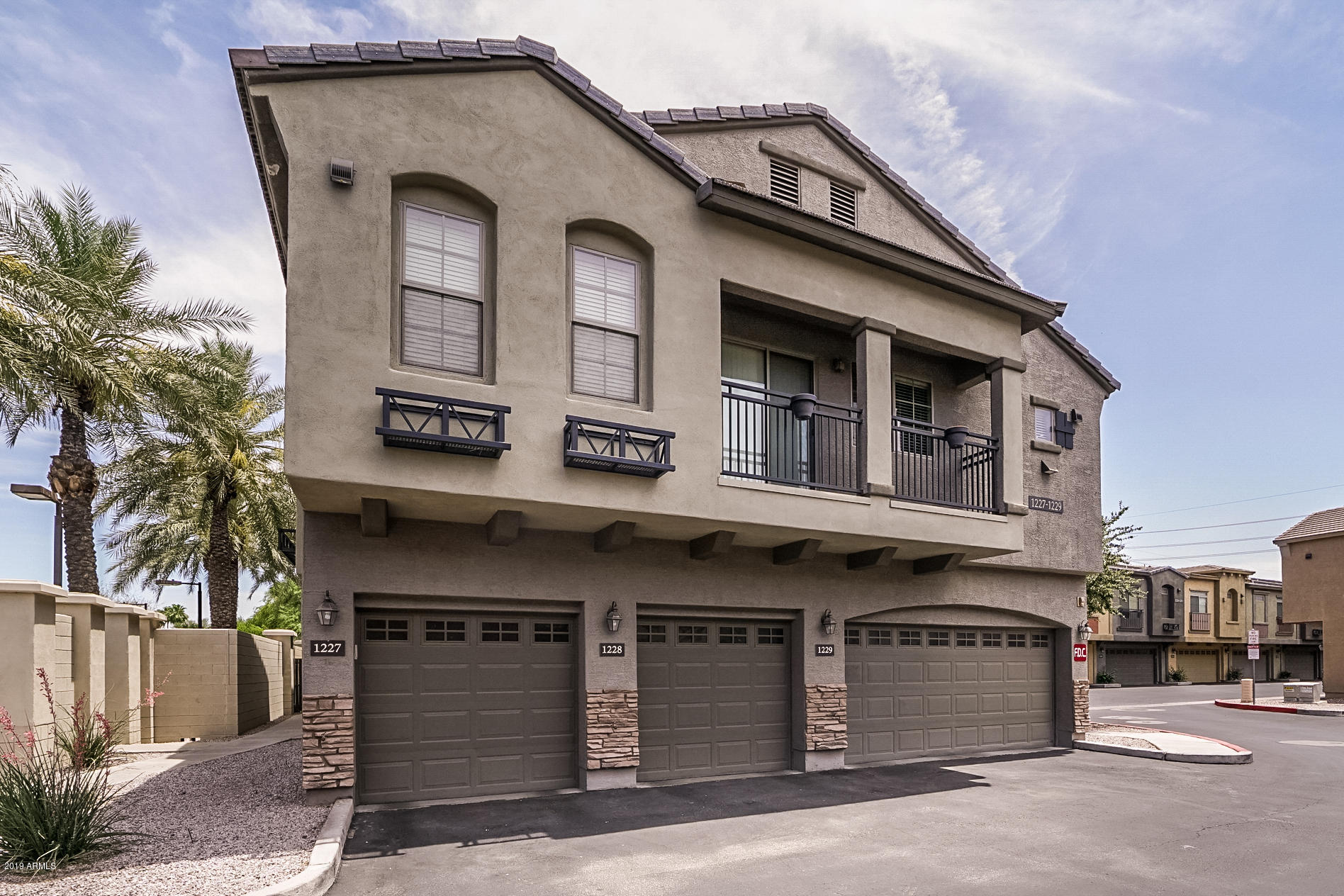 280 South Evergreen Road, Unit 1229 Tempe, AZ 85288 - Photo 1 of 31 a front view of a building with a garage