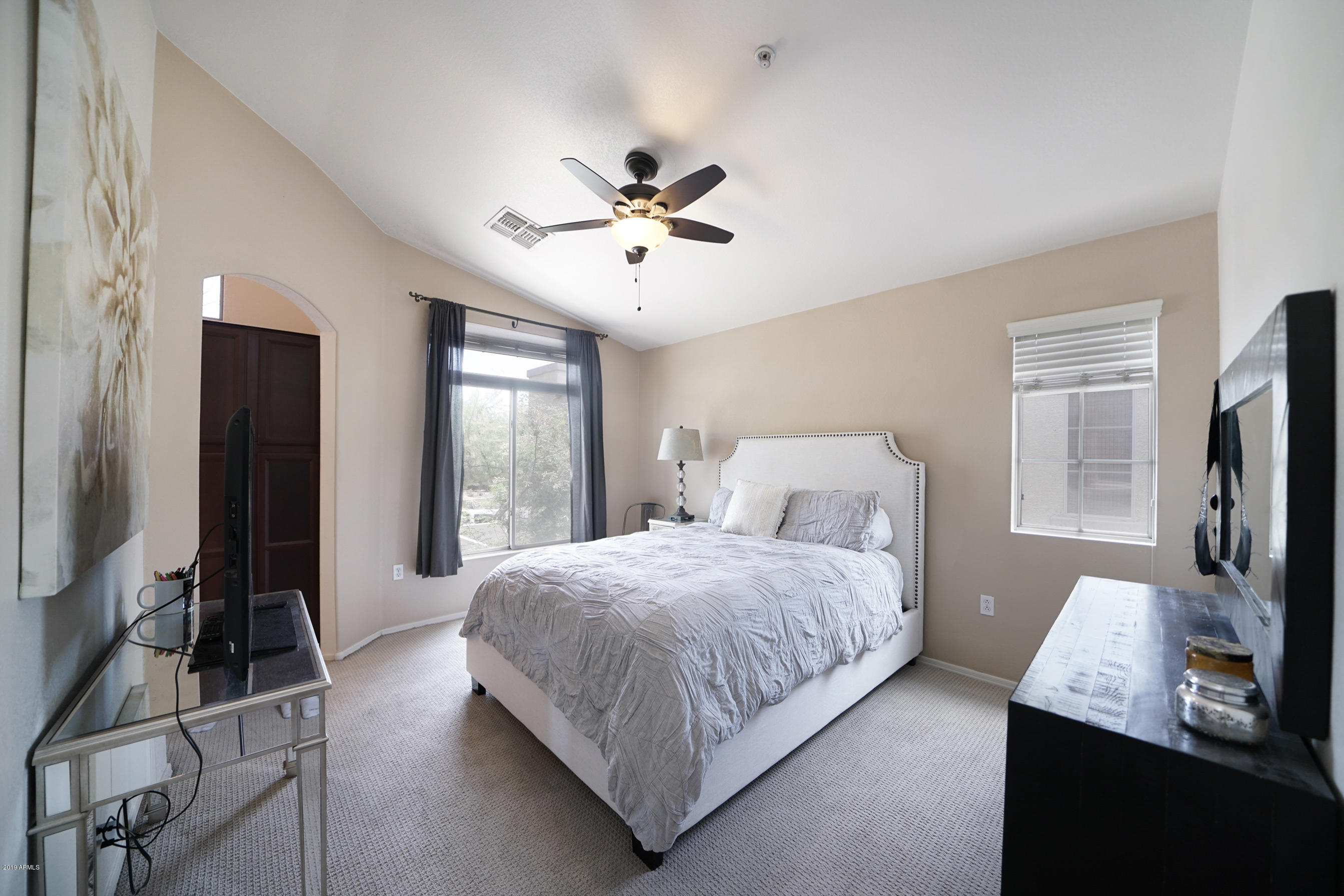 280 South Evergreen Road, Unit 1229 Tempe, AZ 85288 - Photo 12 of 31 a bedroom with a bed flat screen tv and a window