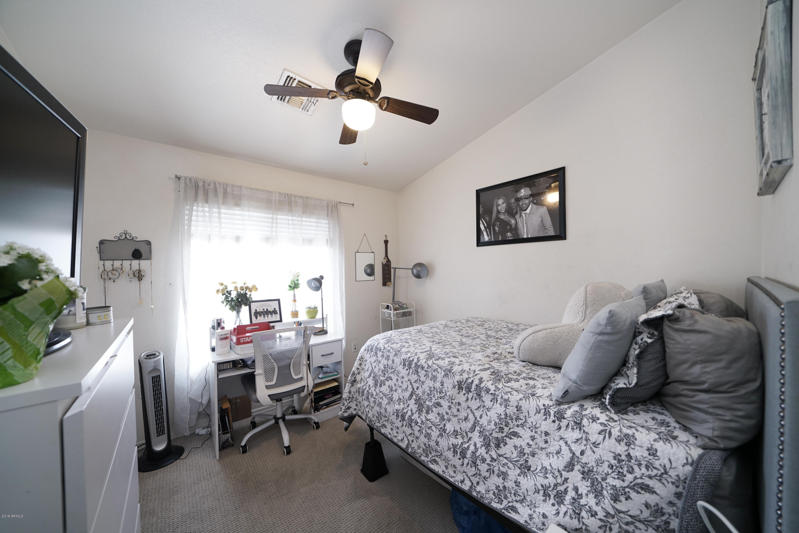 280 South Evergreen Road, Unit 1229 Tempe, AZ 85288 - Photo 19 of 31 a bedroom that has a bed and a chair in it