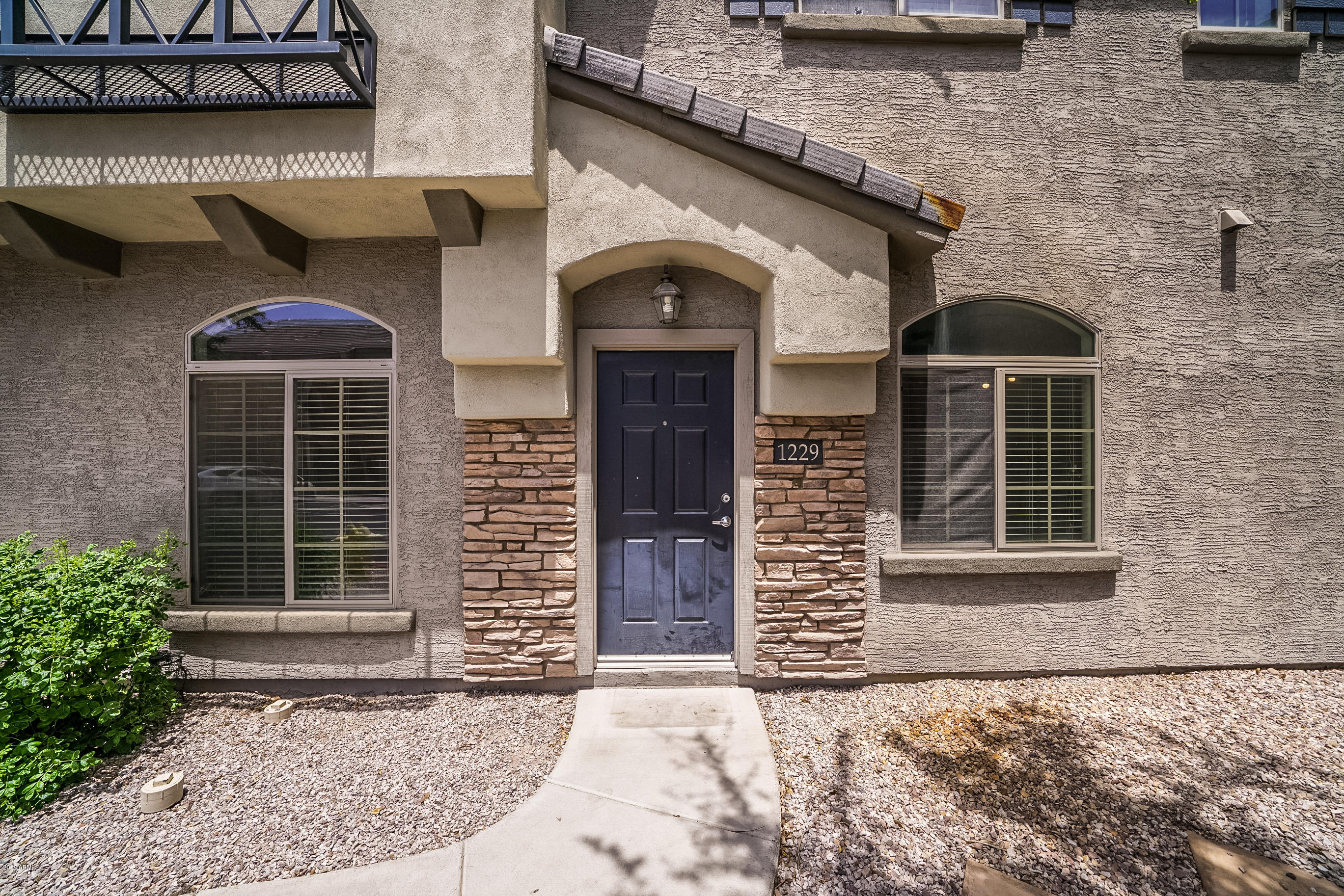 280 South Evergreen Road, Unit 1229 Tempe, AZ 85288 - Photo 2 of 31 a front view of a house with a large windows