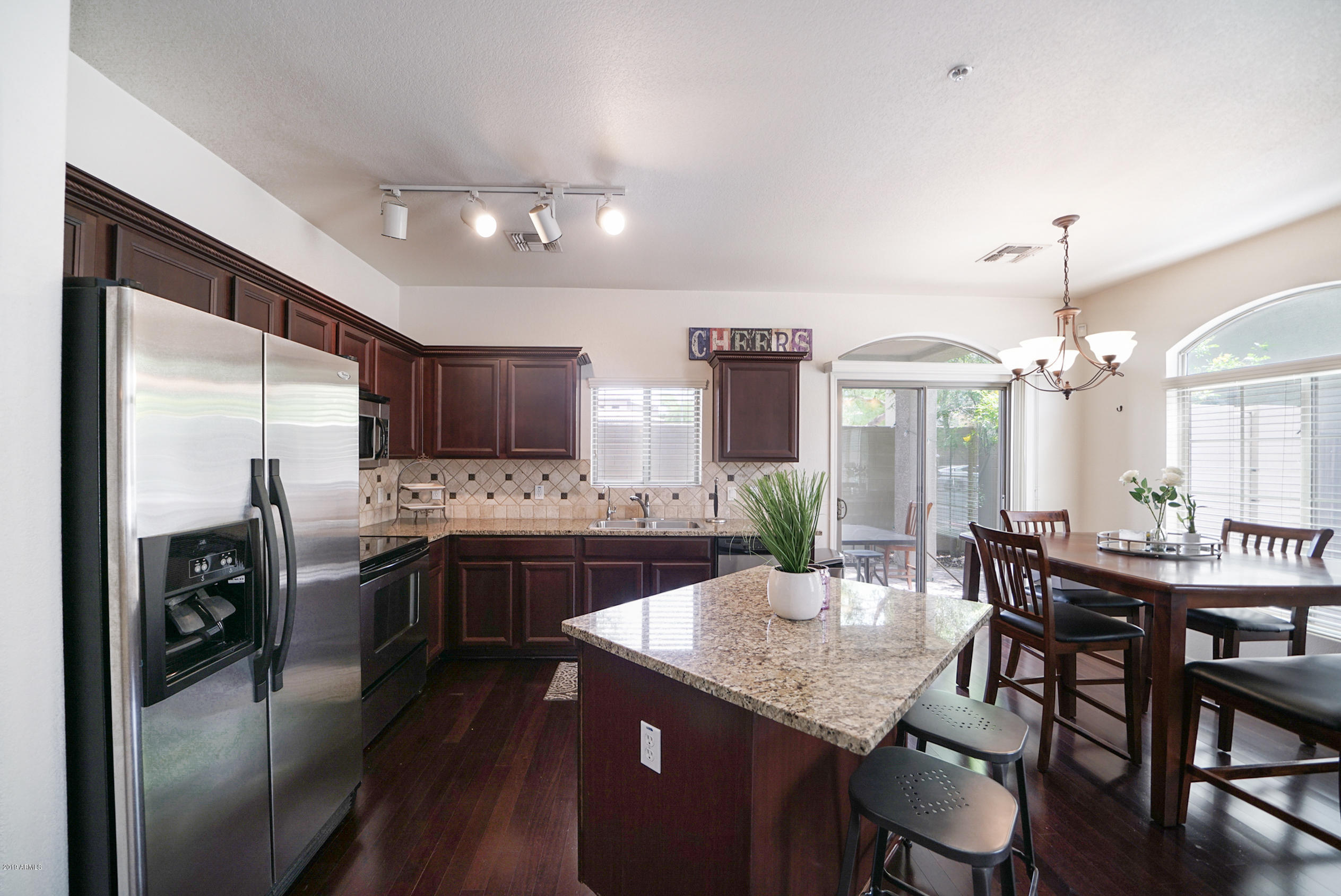 280 South Evergreen Road, Unit 1229 Tempe, AZ 85288 - Photo 3 of 31 a kitchen with a table chairs stove and refrigerator