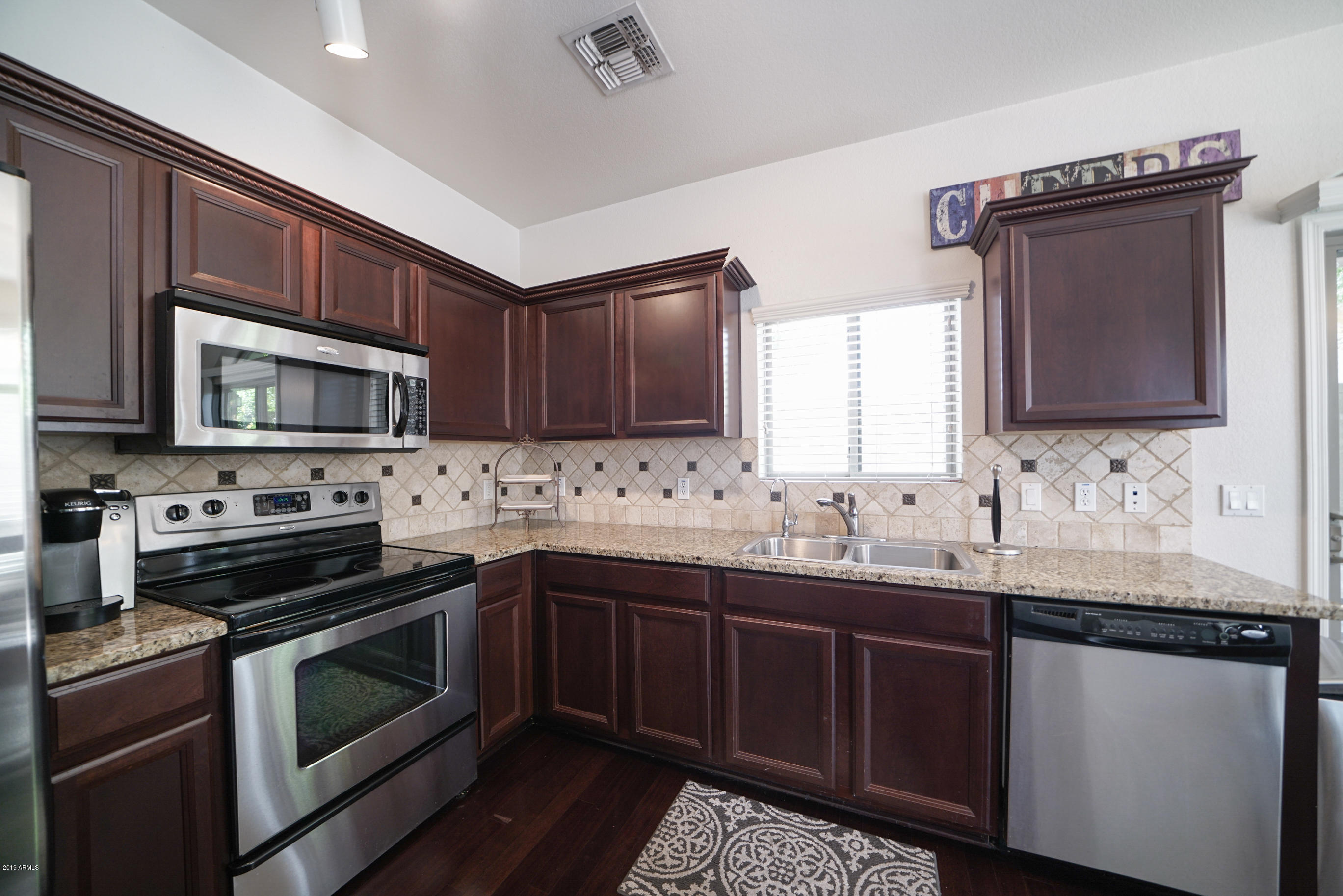 280 South Evergreen Road, Unit 1229 Tempe, AZ 85288 - Photo 6 of 31 a kitchen with stainless steel appliances granite countertop a sink stove and microwave