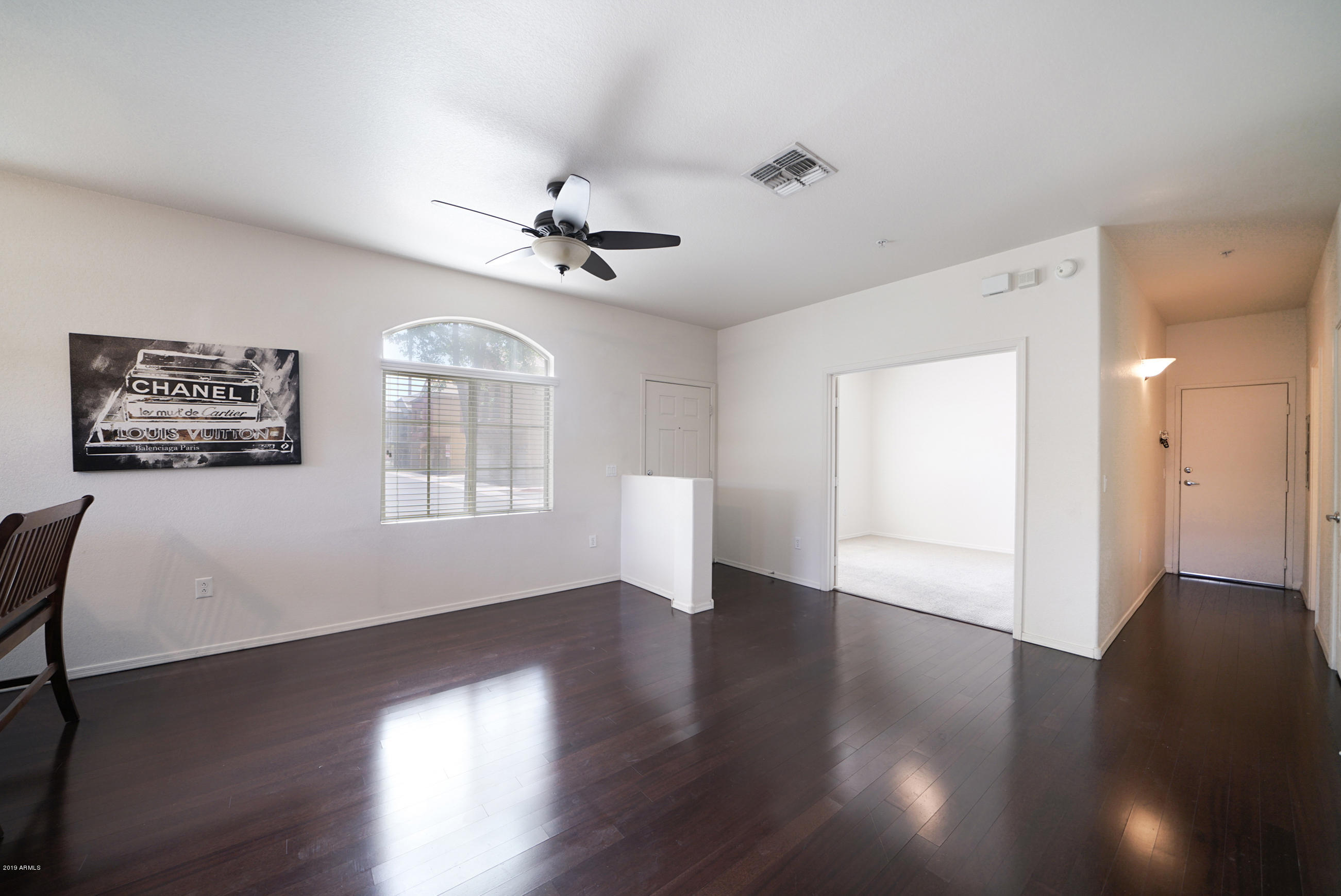 280 South Evergreen Road, Unit 1229 Tempe, AZ 85288 - Photo 8 of 31 a view of an empty room with wooden floor and a window