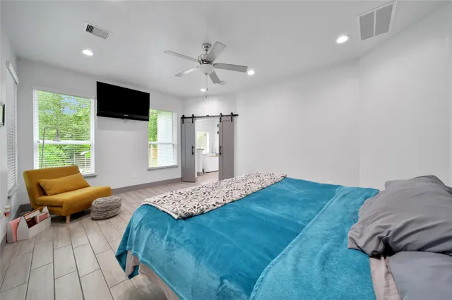 a bedroom with a bed and window