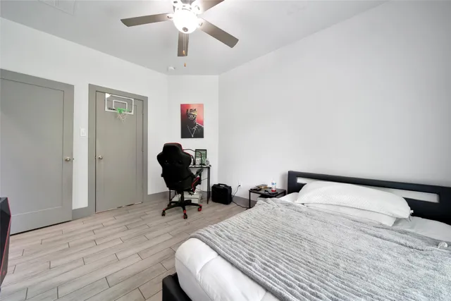 a bedroom with a bed and wooden floor