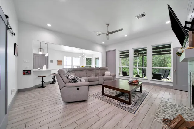 a living room with furniture fireplace and flat screen tv