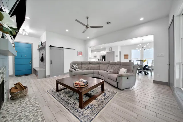 a living room with furniture a flat screen tv and a fireplace
