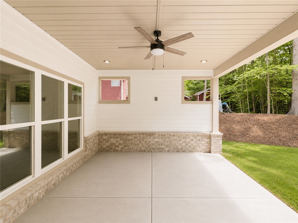 328 Point Road Westminster, SC 29693 - Photo 21 of 24 An inviting covered patio offers a comfortable outdoor living space overlooking lush greenery.