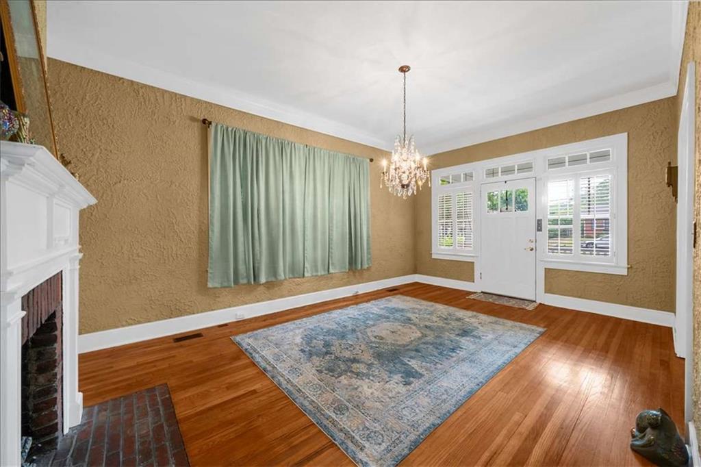 106 Westmore Road Southwest Rome, GA 30165 - Photo 8 of 56 a view of an empty room with window and wooden floor