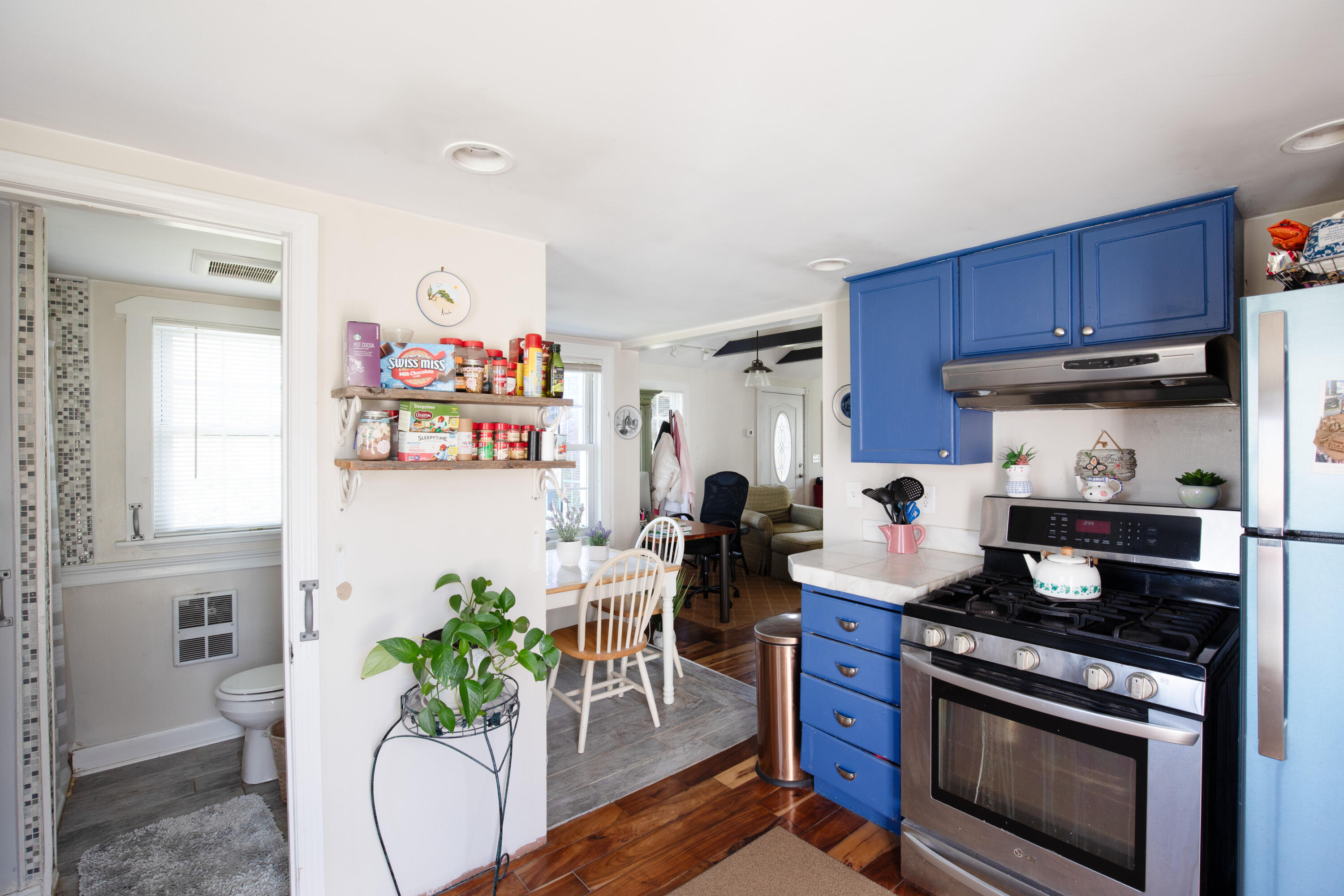 39 Lovell's Lane Mashpee, MA 02649 - Photo 18 of 24 a kitchen with stainless steel appliances a stove a chimney a dining table and chairs