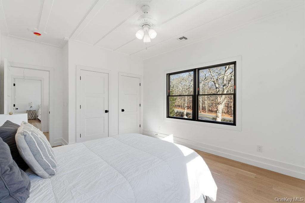 768 Bridgehampton Sag Harbor Bridgehampton, NY 11932 - Photo 23 of 35 Bedroom featuring light wood-type flooring, attic access, and ceiling fan