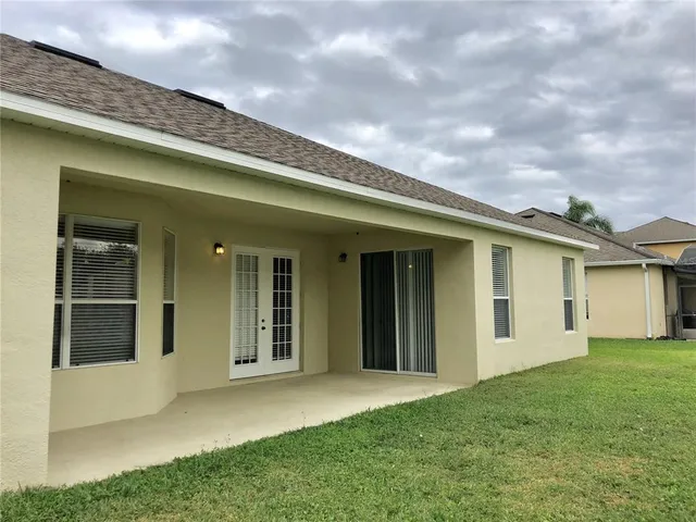 a view of a house with brick walls and a yard