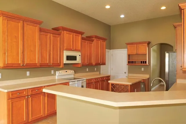 a kitchen with stainless steel appliances granite countertop a sink and a microwave