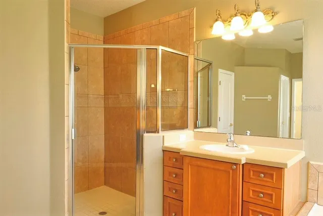a bathroom with a double vanity sink and a mirror