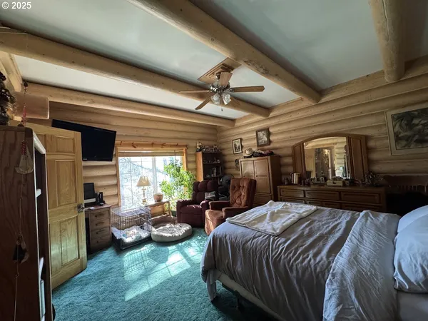 a bedroom with a bed a couch and dresser