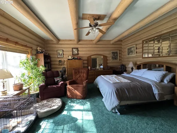 a bed room with bed and a large window