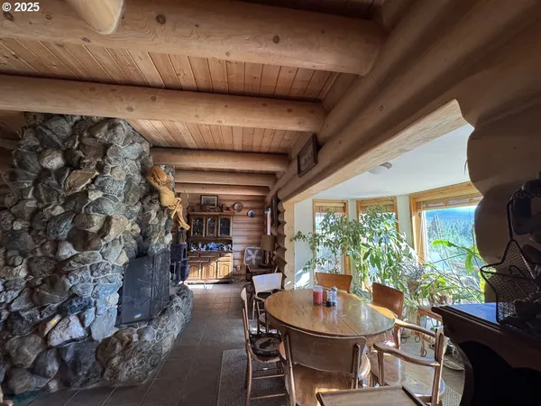 a dining room with furniture and a floor to ceiling window