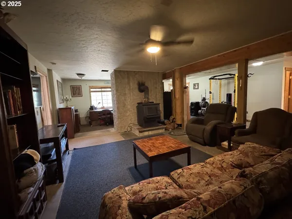 a living room with furniture lamp and a flat screen tv