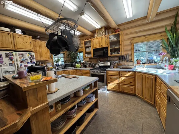 a open kitchen with stainless steel appliances granite countertop a stove and a sink