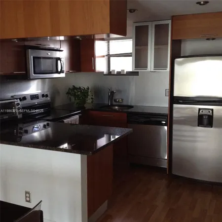 a kitchen with a sink and a microwave