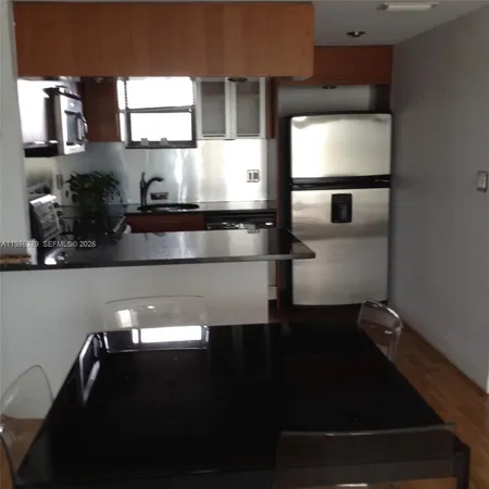 a kitchen with a sink stainless steel appliances and cabinets