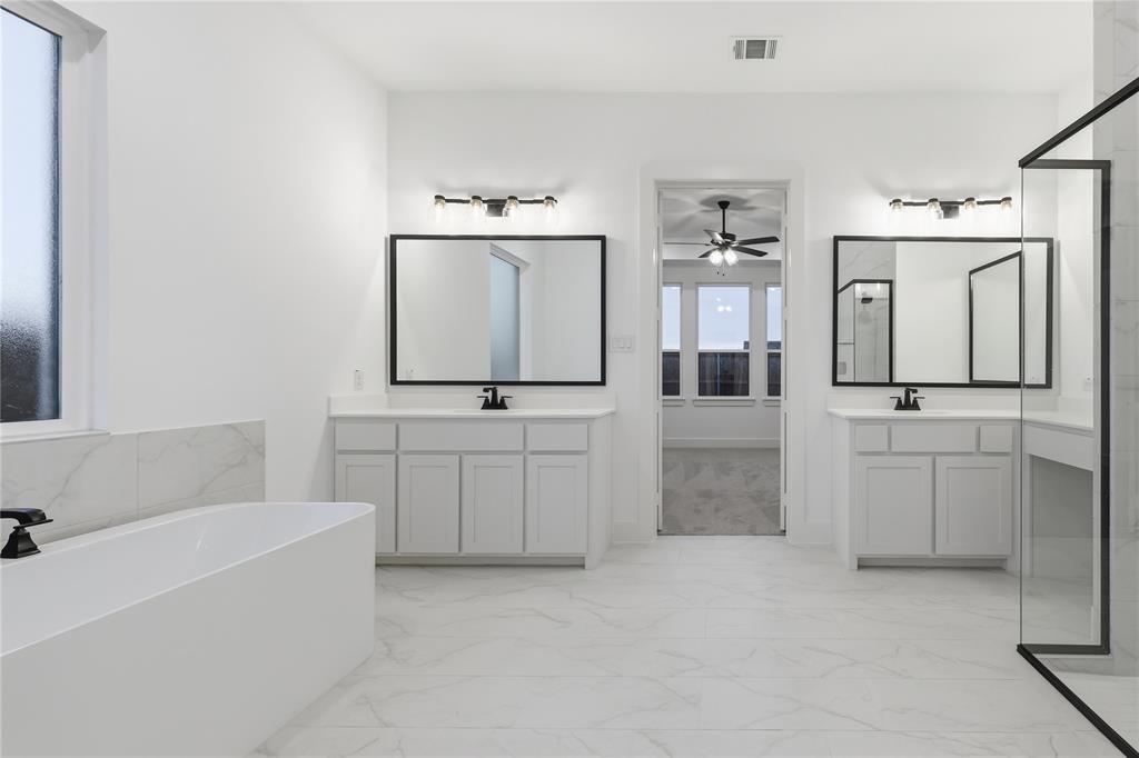 1653 Cedar Elm Way Burleson, TX 76028 - Photo 14 of 26 a bathroom with a bathtub sink and mirror