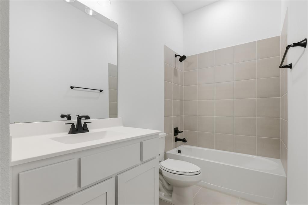 1653 Cedar Elm Way Burleson, TX 76028 - Photo 20 of 26 a bathroom with a sink a toilet and shower
