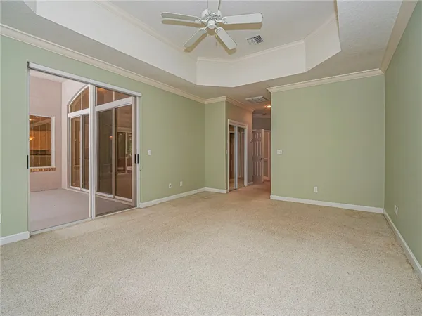 an empty room with closet and a ceiling fan