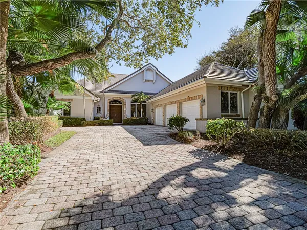 a house with lots of trees in front of it