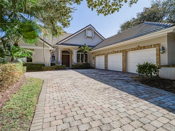 a front view of house with yard and trees around