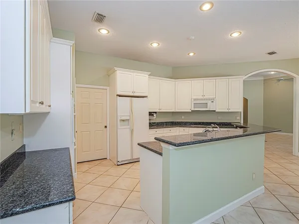 a kitchen with a stove a sink and a refrigerator