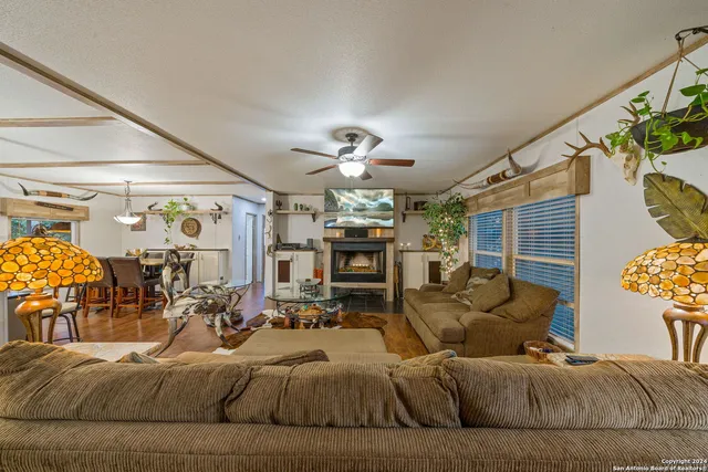 a living room with fireplace furniture and a chandelier
