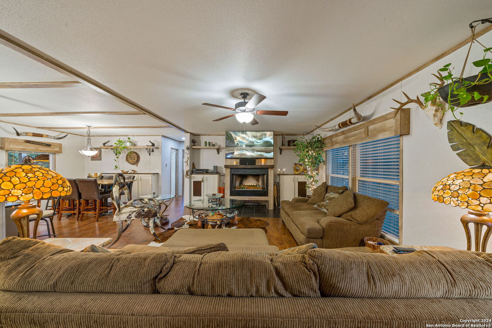 a living room with fireplace furniture and a chandelier