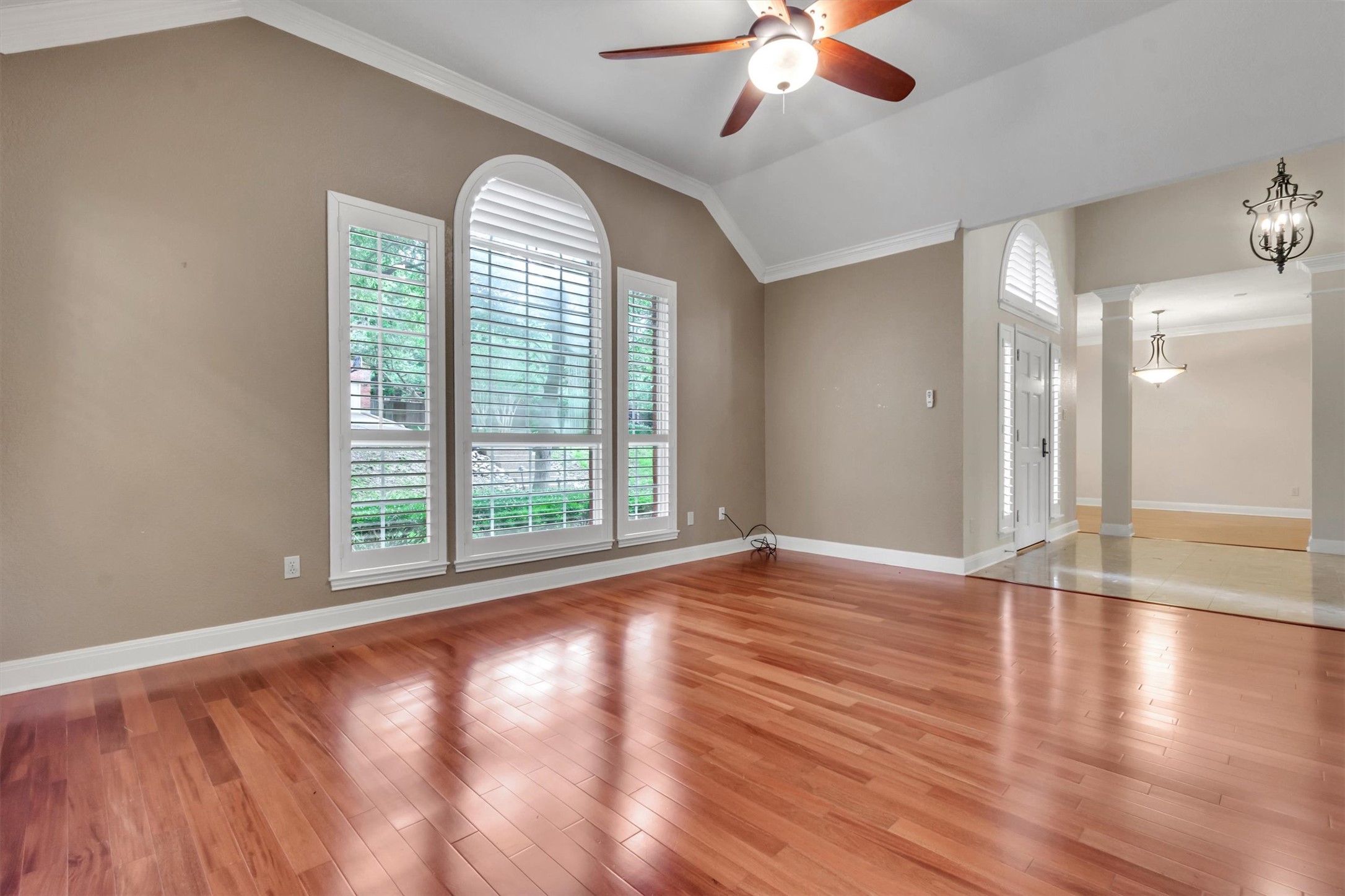 6008 Tributary Ridge Court Austin, TX 78759 - Photo 4 of 36 Natural light floods this living area, highlighting polished hardwood floors and high vaulted ceilings.