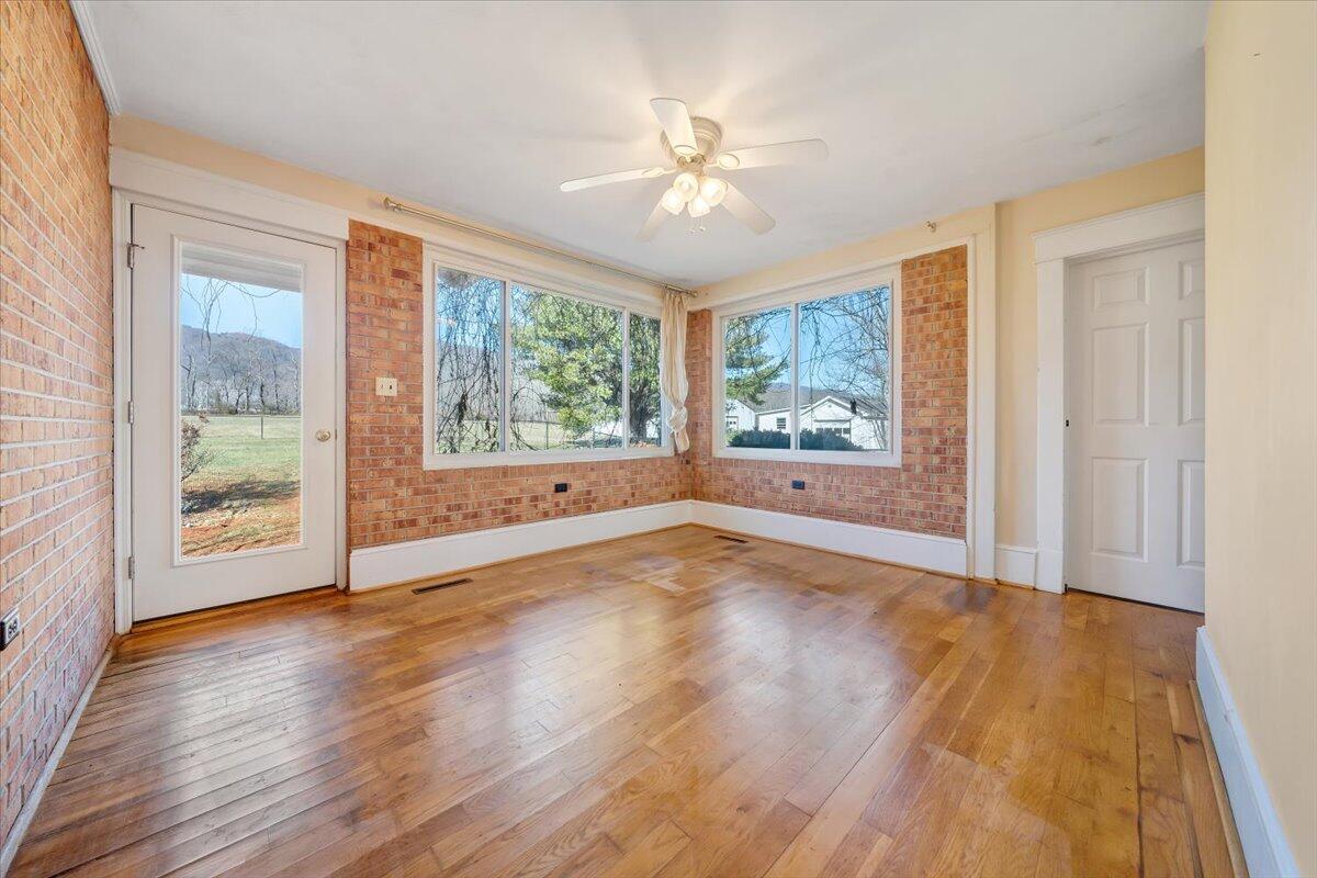 181 Chestnut Grove Road Callaway, VA 24067 - Photo 21 of 51 a view of an empty room with wooden floor and a window