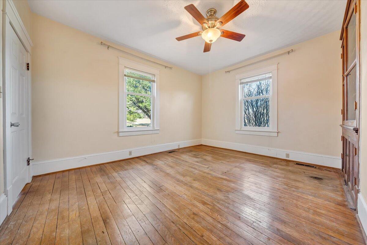 181 Chestnut Grove Road Callaway, VA 24067 - Photo 22 of 51 a view of an empty room with wooden floor and a window